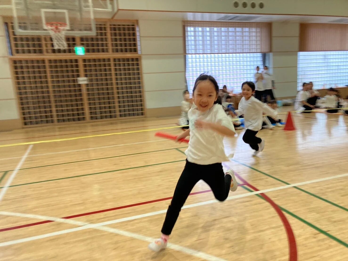 体育館でリレーをする子どもたち