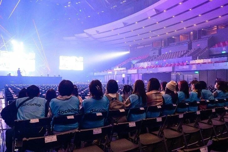 ドコモのスタッフと思われる人々がステージを向いているイベント会場の様子